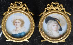 A pair of antique style hand painted porcelain plaques, within miniature frames.