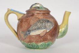 A 19th century Victorian ceramic Majolica tea pot embossed with fish possibly Perch