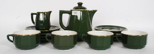 A Green glazed ceramic tea service having gilt band design along marks to base