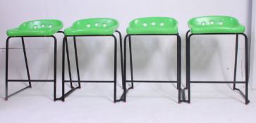 A set of 4 20th century Industrial metal stools having green pierced plastic seats raised on