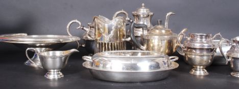 A large lot of antique silverplate items to include tea sets, candlesticks,