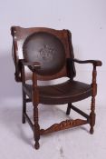 A 1920's oak and faux leather monks chair / table seat.