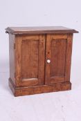 A vintage oak wall hanging medical cabinet having a fully appointed interior consisting of drawers