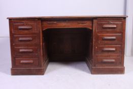 A 1920's large oak twin pedestal Industrial office desk.