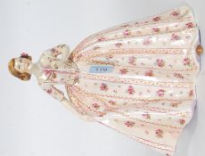 A Royal Worcester figurine entitled ' The Duchess's Dress by Freda G Doughty.