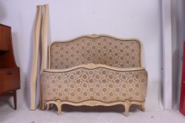 A 1930's French Louis XV style corbeille painted tapestry upholstered bow front double bed having