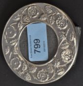 A white metal 925 silver embossed picture frame on an easel back