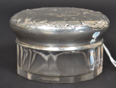 A continental  800 marked silver lidded dressing table pot having cut glass base.