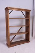 A large Victorian country pine open window bookcase shelf having open back with flared cornice.