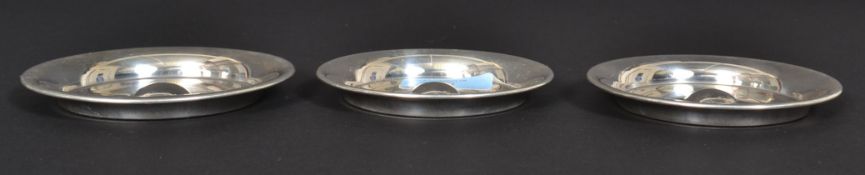 A set of 3 graduating silver hallmarked peanut dishes of circular form being engine turned.