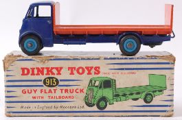 DINKY; An original vintage Dinky diecast model 913 Guy Flat Truck in orange and blue.