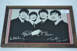 A vintage small Beatles advertising mirror, depicting all four Beatles and signatures.
