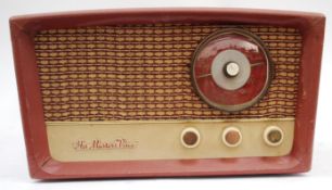 A vintage 1950's HMV portable two tone record player having hinged top with deck inside.