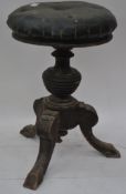 A Victorian mahogany revolving adjustable Victorian piano stool on tripod base with circular swivel