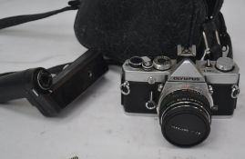 An Olympus OM-1 slr camera serial no 1739728 with an attached Olympus F.Zuiko 50 mm lens.