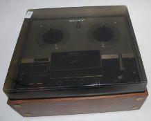 A Sony Solid State Stereo Tapecorder with smoked acryllic top and teak body having Ferrite &