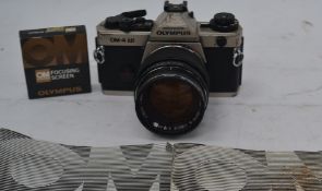 An Olympus OM-4 Ti slr camera serial no 1132287 with an attached Olympus G.