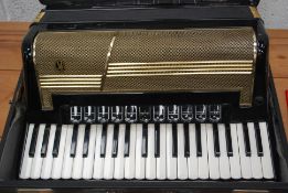 A vintage Hohner Accordion musical instrument, within the original case.