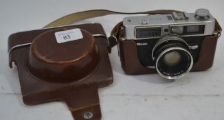 A leather cased vintage 35mm camera by Ricoh with original carry straps

UK,