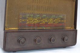 A vintage Bakelite cased Sobell valve radio, four bakelite knobs to front, front facing speaker

UK,