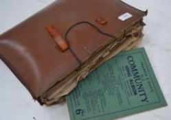 A collection of vintage sheet music from the 20th century all contained within a leather music