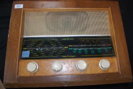 A vintage Bush UK, valve radio, original wooden case with logo to top and dials to front.