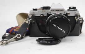 A vintage Olympus OM10 SLR camera with Olympus OM - System Zuiko MC Auto-s lens f=50 mm.