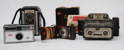 A vintage Coronet binocular viewfinder together with a Kodak Dua flex II camera, Triumph Flashgun,
