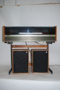 A vintage retro teak cased Deccasound compact 2 record player and radio on original 1970's stand