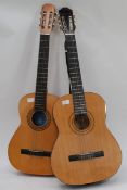 A Burswood six string accustic guitar along with another six string Spanish accustic guitar.