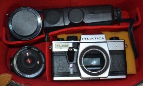 A vintage cased 35mm Praktika camera and lenses, flash head and other accessories.