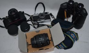 A collection of cameras and lenses to include a boxed Sigma 28-70mm f2.
