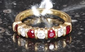 An 18ct gold ruby garnets and diamond la