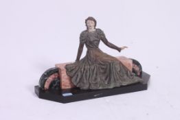 An Art Deco plaster figurine of a recumb