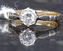 An 18ct gold platinum and diamond ring. The central stone approx 20pnts set within platinum mount.