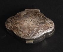A silver scalloped form pill / snuff pot, having a hinged chased decorated lid,