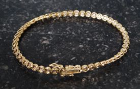 A ladies 18ct tennis bracelet with inset stones. Total weight 7.