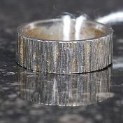An 18ct white gold ladies ring - eternity band having bark like effect detailing.
