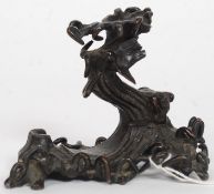 An early 20th century Asiatic bronze figurine of a tree with bird raised on naturalistic plinth