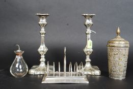2 good quality silver plate candlesticks together with a silver and glass oil bottle and a toast