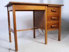 A 1940's golden oak Air Ministry style clerks desk raised on squared legs with pedestal of drawers