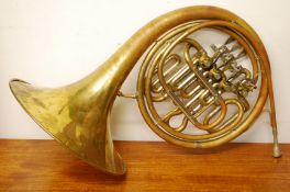 A late 19th early 20th century brass French horn, inscribed ALLIANCE J.R.
