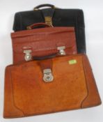 A collection of three vintage leather briefcases