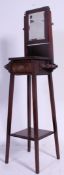 An Edwardian mahogany shaving stand having squared legs with central raised drawer having swing