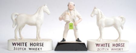 2 vintage 20th century White Horse Scotch whisky horse figurines on plinths together with jolly