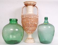 Two large 20th century glass bottles, along with a reproduction Grecian urn vase,