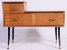 An unusual vintage 1950s - mid 20th century side unit in oak being raised on ebonised sputnik style