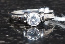 An 18ct white gold diamond single stone solitaire ring with rub over setting,