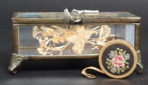 A vintage decorative bevelled glass jewellery casket with inset pressed flower decoration.