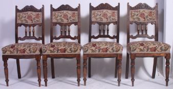 A set of 4 Edwardian oak Art Nouveau dining chairs being raised on tapered  turned supports with